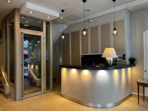 a lobby with a bar with a lamp on it at Hotel Viator - Gare de Lyon in Paris
