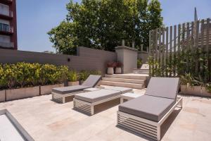 a patio with two chairs and a bench at Premium Apt 2BR 24x7 San Telmo 300 Mb La Galerie in Buenos Aires