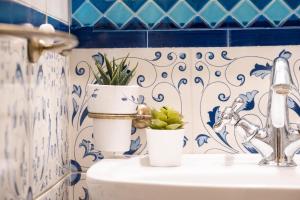 a bathroom with a sink with two potted plants on it at Villino Simona in Viareggio +30 photos