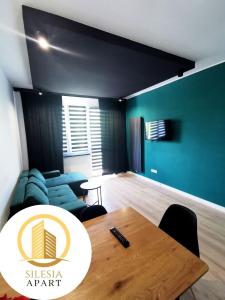 a living room with a table and a couch at Apartament Zielony in Tychy