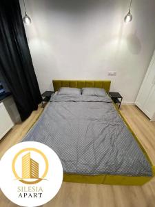a bedroom with a large bed in a room at Apartament Zielony in Tychy