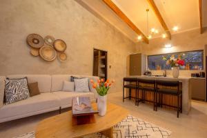 a living room with a couch and a table at The Duchess Luxury Safari Villa, Close to KNP, Giraffe-Feeding-Tower, Bush-Bath, Boma in Marloth Park