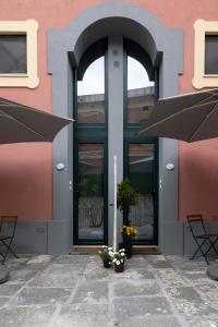 un edificio con due tavoli e due ombrelloni davanti di PALAZZO PELLEGRINO vietri a Vietri