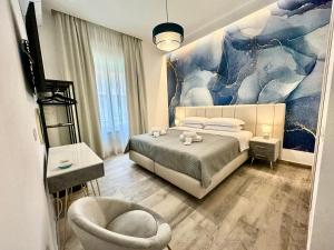a bedroom with a bed and a chair at Le Dimore di Lorenzo in Naples