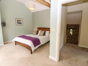 a bedroom with a bed in a room at Old Crow Trees Barn in Melling