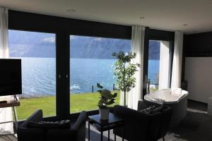 a living room with a view of the water at Ferienvilla am See 3 für 2-4 Personen in Sisikon