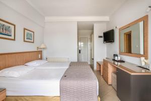 a hotel room with a bed and a sink at Danae Hotel in Egina