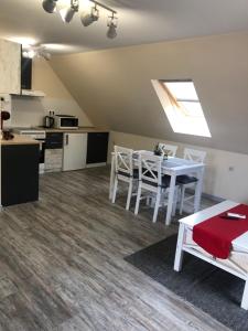 a kitchen and dining room with a white table and chairs at Sunpark Apartment in Sandanski
