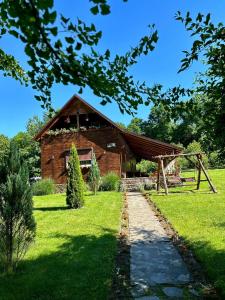 a barn with a pathway in front of it at Cabana Oana 5-bedrooms chalet in Arad