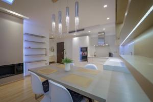 a kitchen and dining room with a table and chairs at The View Luxury Apartment Center in Sarandë