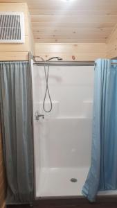 a bathroom with a shower with a shower curtain at Lighthouse Cabins Maine in Bass Harbor