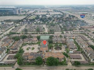 an aerial view of a parking lot with a red marker at 3 Bedrooms Spacious Central Condo w Pool in Houston