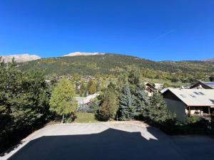 an aerial view of a driveway with a house and a mountain at L'Aiglon 217 in La Salle Les Alpes