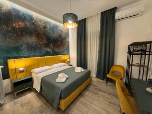 a hotel room with a bed and a chair at Le Dimore di Lorenzo in Naples