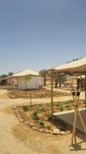 a group of buildings in the middle of a field at Selina Tzukim - Soft opening - סלינה צוקים in Zuqim