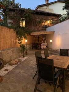 an outdoor patio with a wooden table and chairs at Sunny Antalya VILLA in kale içi Antalya 7 persoons in Antalya
