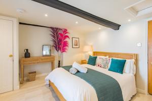 a bedroom with a large bed and a fireplace at Abode in Sandwich in Kent