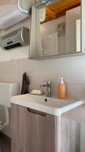 a bathroom with a sink and a mirror at Goričko view house in Križevci +14 photos