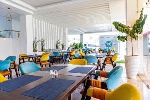 a restaurant with tables and chairs in a room at Muthu Warwick Mount Kenya Hotel, Nanyuki in Nanyuki