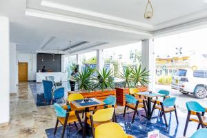 a restaurant with tables and chairs in a room at Muthu Warwick Mount Kenya Hotel, Nanyuki in Nanyuki