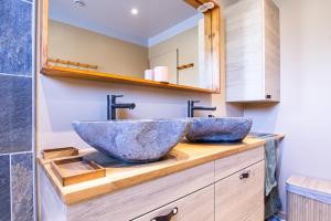a bathroom with a large stone sink on a wooden counter at La Maison du Lac - Puimoisson in Puimoisson +31 photos