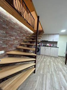 a staircase in a room with a brick wall at Танхаус in Dilijan