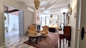 a living room with chairs and a table and a bedroom at Boutique B&B Número Cuatro in Benissa +50 photos