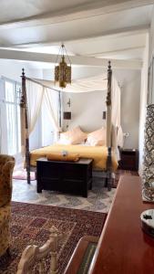 a bedroom with a bed with a canopy at Boutique B&B Número Cuatro in Benissa
