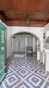 a room with a blue bench and a tile floor at Boutique B&B Número Cuatro in Benissa