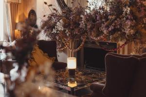 a living room with a vase of flowers on a table at No 15 by GuestHouse, Bath in Bath