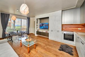 a living room with a couch and a table at Luxury Sea View Apartment in Pomorie in Pomorie +5 photos