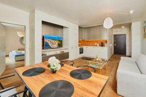 a living room with a table and a couch at Luxury Sea View Apartment in Pomorie in Pomorie