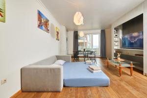 a living room with a couch and a table at Luxury Sea View Apartment in Pomorie in Pomorie