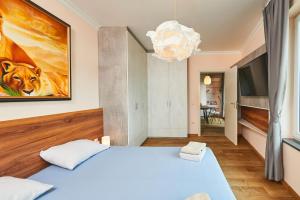 a bedroom with a bed and a painting on the wall at Luxury Sea View Apartment in Pomorie in Pomorie