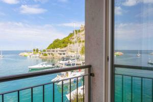 a balcony with a view of the water and boats at Portopiccolo Apartments in Sistiana