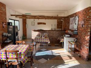 a kitchen with a table and a brick wall at La Fornace in Garessio