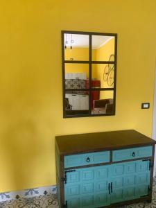a mirror above a dresser in a room at Ostello 9 in Castelnuovo Cilento