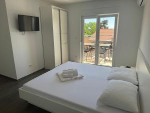 Postel nebo postele na pokoji v ubytování Apartments Vinko