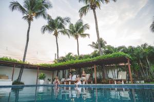 a group of people in the swimming pool at a resort at Vila Aytana in Paracuru