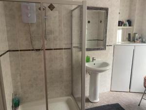 a bathroom with a shower and a sink at Derry City center townhouse in Derry Londonderry