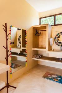 a room with wooden cabinets and a mirror at Atenea Holbox in Holbox Island