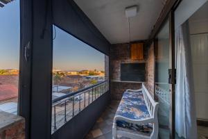 a balcony with a bench and a view at Hetta's@Delmar in Jeffreys Bay