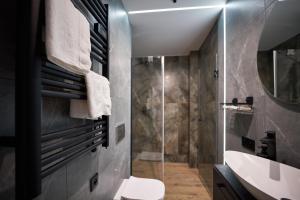 a bathroom with a shower and a toilet and a sink at Apartamenty Panorama in Łódź +61 photos