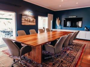 a dining room with a large wooden table and chairs at Hilltop Boutique Hotel in Victoria Bay