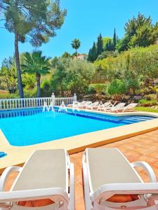 een zwembad met ligstoelen en een zwembad bij Ca Adelfa in Muntanya la Sella