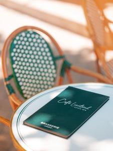 a plate on a table with a sign on it at Hôtel Liautaud Rooftop Cassis in Cassis