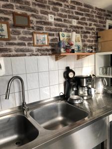 a kitchen with a stainless steel sink in a kitchen at The RustyCorner- zuhause in Solingen in Solingen