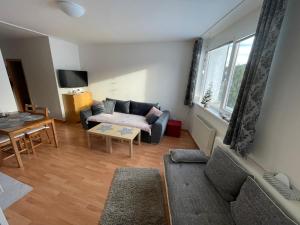 a living room with a couch and a table at Apartmán 6 Triangel in Donovaly
