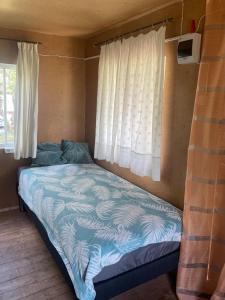 een bed in een kleine kamer met een raam bij Grandma's summer house in Ludza