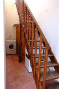 a staircase in a house with a washing machine at Villa de Palma a Ribeira D.Joao in Figueira da Horta